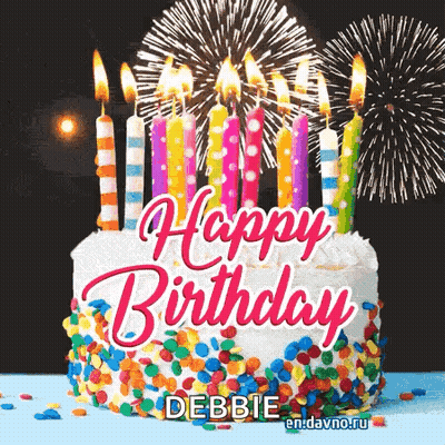 A Birthday Cake With Candles And Fireworks Behind It GIF
