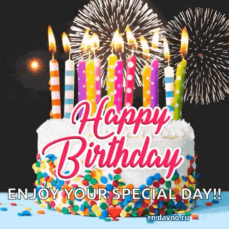 A Birthday Cake With Candles And Fireworks In The Background GIF