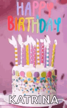 A Birthday Cake With Candles And Sprinkles On A Pink Background . GIF