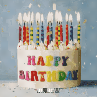 A Birthday Cake With Candles And The Words Happy Birthday Julie On It GIF
