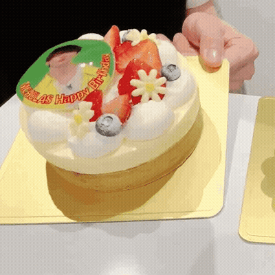 A Birthday Cake With Strawberries And Blueberries And The Words Nicolas Happy Birthday GIF