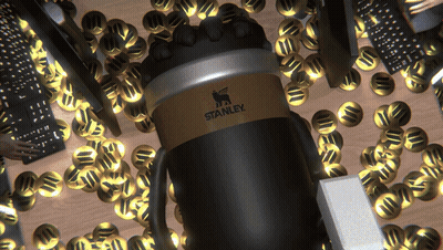 A Black And Gold Stanley Coffee Mug Is Surrounded By Gold Coins GIF