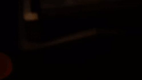 A Black And Red Robot With A Circle In The Middle Of It GIF