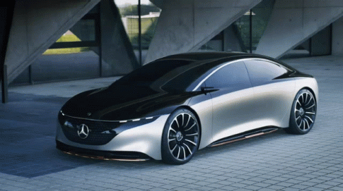 A Black And Silver Mercedes Is Parked On A Brick Sidewalk GIF