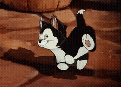 A Black And White Cartoon Cat Is Walking On A Rocky Surface . GIF