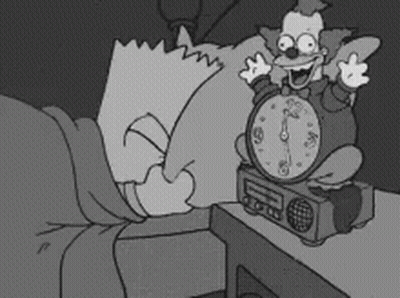 A Black And White Cartoon Of Bart Simpson Laying In Bed Next To A Clown Alarm Clock GIF