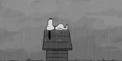 A Black And White Cartoon Of Snoopy Laying On A Doghouse In The Rain . GIF