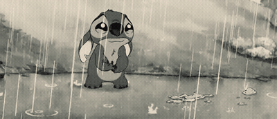 A Black And White Cartoon Of Stitch Standing In The Rain With A Sad Look On His Face GIF