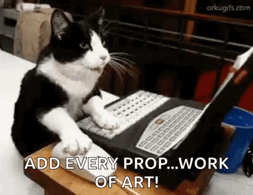 A Black And White Cat Is Sitting At A Laptop Computer . GIF