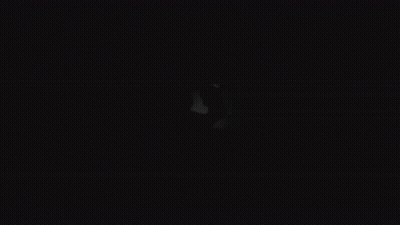 A Black And White Drawing Of A Person 'S Face With Big Eyes In The Dark . GIF