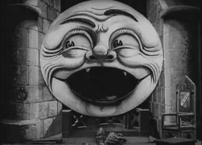 A Black And White Drawing Of A Smiling Face In Front Of A Castle Tower GIF
