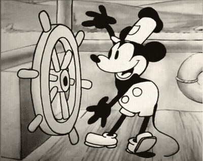 A Black And White Drawing Of Mickey Mouse With A Steering Wheel GIF