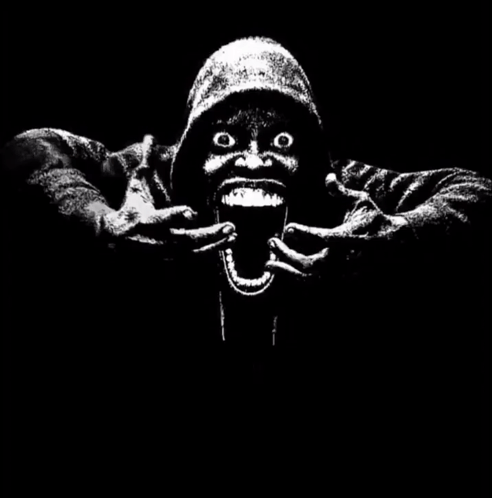 A Black And White Image Of A Man With His Mouth Open And A Hand Holding A Sign That Says 67 < 61 GIF