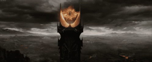 A Black And White Image Of A Tower With A Glowing Eye GIF