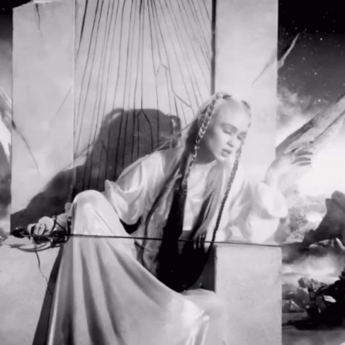 A Black And White Painting Of A Woman With Long Hair GIF
