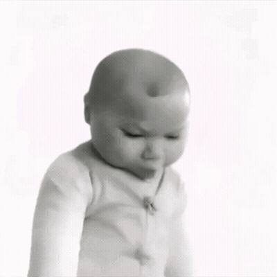 A Black And White Photo Of A Baby Looking Down GIF