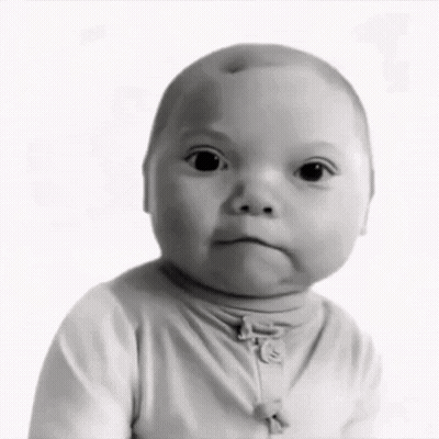 A Black And White Photo Of A Baby Wearing A Turtleneck GIF
