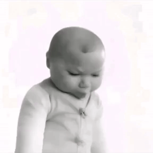 A Black And White Photo Of A Baby Wearing A White Sweater . GIF