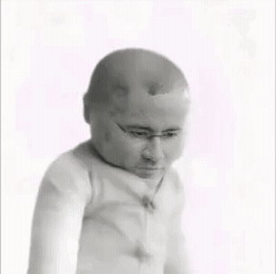 A Black And White Photo Of A Baby With A Bald Head GIF