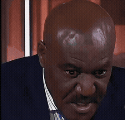 A Black And White Photo Of A Bald Man Wearing A Black Suit And Tie GIF