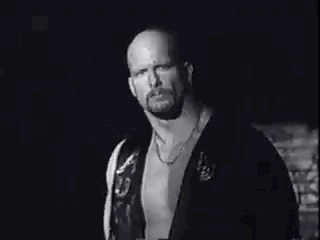 A Black And White Photo Of A Bald Man With A Beard Making A Funny Face . GIF