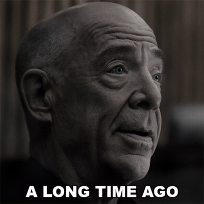 A Black And White Photo Of A Bald Man With The Words A Long Time Ago Below Him GIF