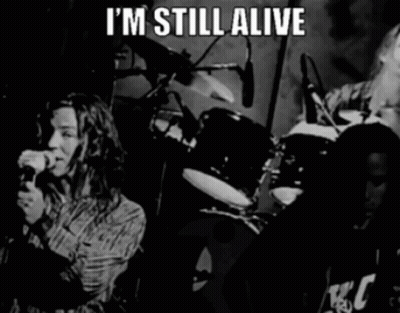A Black And White Photo Of A Band With The Words " I 'M Still Alive " GIF