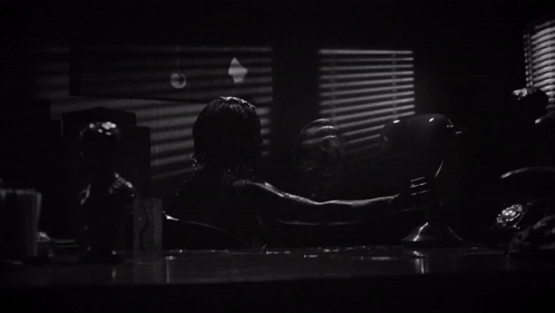 A Black And White Photo Of A Banker 'S Lamp In Front Of A Window GIF