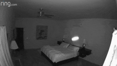 A Black And White Photo Of A Bedroom With The Website Ring.com GIF
