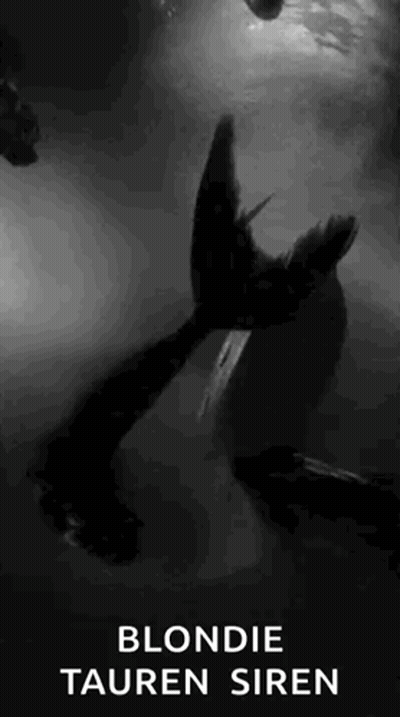 A Black And White Photo Of A Blonde Tauren Siren In The Water . GIF