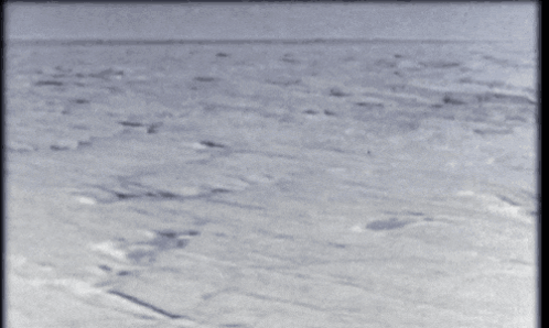 A Black And White Photo Of A Body Of Water With A Few Waves GIF