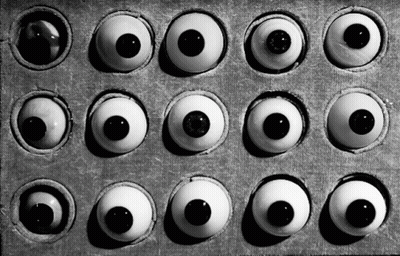A Black And White Photo Of A Box Of Eyes GIF