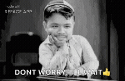 A Black And White Photo Of A Boy Sitting At A Table With His Hand On His Chin And A Thumbs Up . GIF