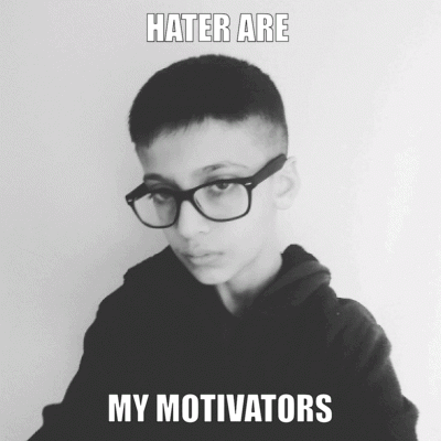 A Black And White Photo Of A Boy Wearing Glasses With The Caption " Hater Are My Motivators " GIF