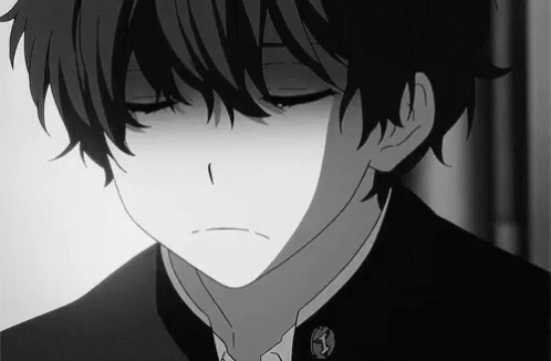 A Black And White Photo Of A Boy With His Eyes Closed And A Sad Look On His Face . GIF
