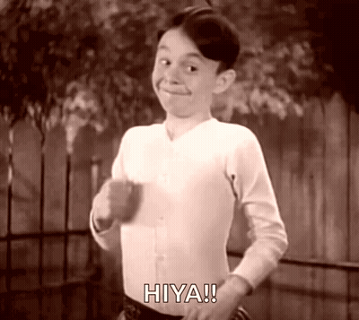 A Black And White Photo Of A Boy With The Word Hiya On His Shirt GIF