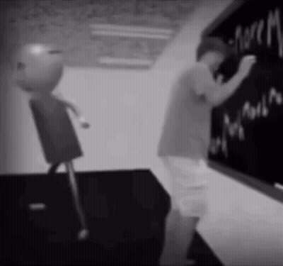 A Black And White Photo Of A Boy Writing On A Chalkboard .. GIF