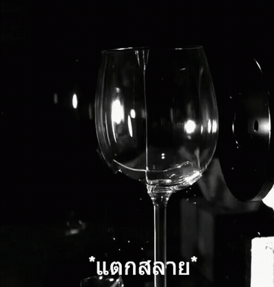 A Black And White Photo Of A Broken Wine Glass With Foreign Writing GIF