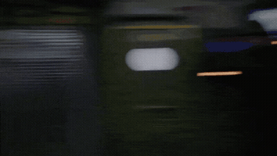 A Black And White Photo Of A Building With A Sign That Says ' Ii ' On It GIF