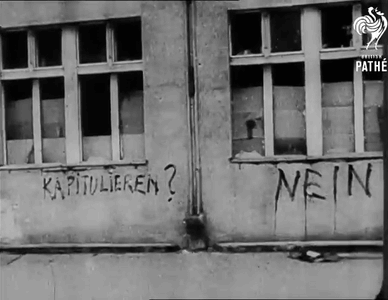 A Black And White Photo Of A Building With Nein Written On It GIF