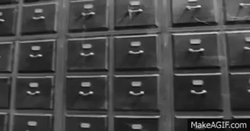 A Black And White Photo Of A Bunch Of Drawers With Numbers On Them GIF