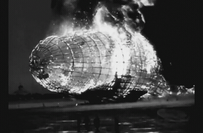 A Black And White Photo Of A Burning Airship With Flames Coming Out Of It GIF