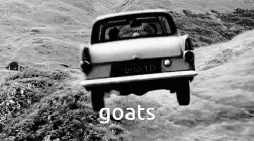 A Black And White Photo Of A Car Driving Down A Hill With The Word Goats Written On The Bottom . GIF
