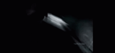 A Black And White Photo Of A Car Going Down A Hill GIF