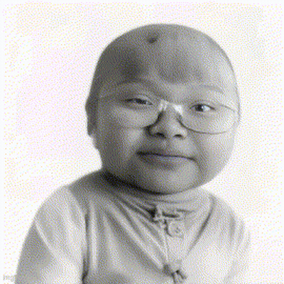 A Black And White Photo Of A Child Wearing Glasses And A Turtleneck GIF
