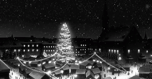 A Black And White Photo Of A Christmas Market With A Christmas Tree In The Middle Of It . GIF