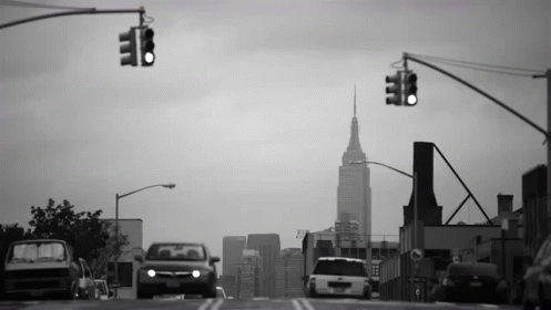 Black And White City Street With Tall Building GIF