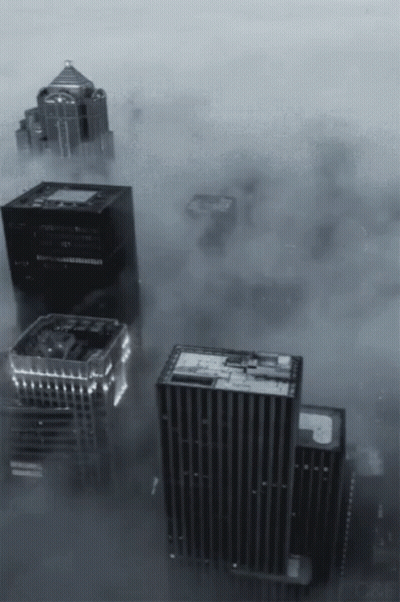 A Black And White Photo Of A City With A Lot Of Buildings GIF