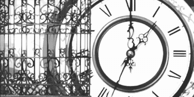 A Black And White Photo Of A Clock With Roman Numerals And A Fence In The Background . GIF