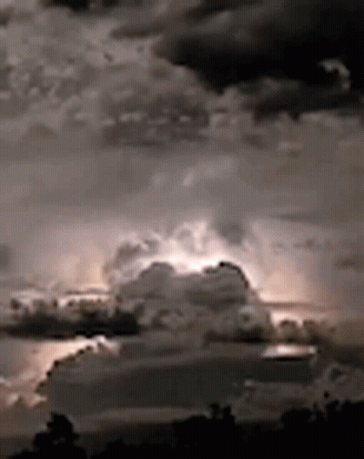 A Black And White Photo Of A Cloudy Sky With Lightning GIF